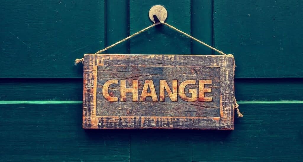 Sign with the word "change" on it, handing on a door.