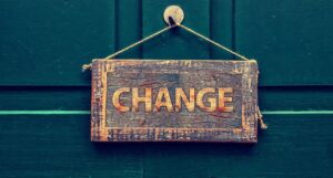 Sign with the word "change" on it, handing on a door.