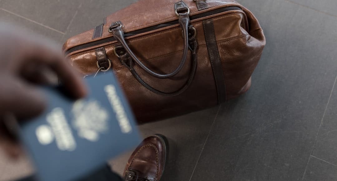 Person traveling with a carry-on bag to illustrate emotional baggage.