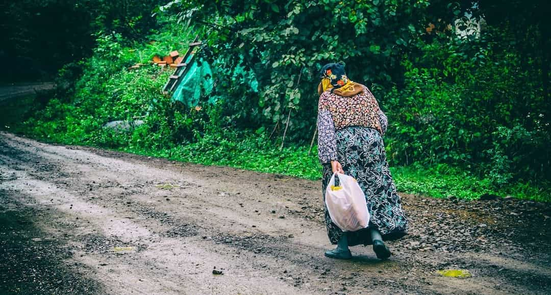 Person who appears like a "bag-lady" to illustrate the fear of being homeless.