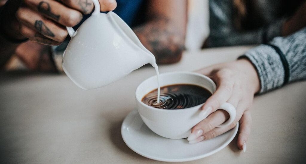 Couple having coffee to discuss their financial and life goals.